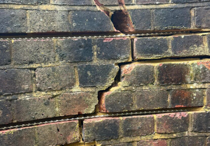 Helibar installer preparing the masonry for crack stitching